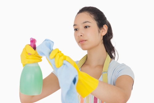 Staff member wearing PPE while preparing professional cleaning equipment